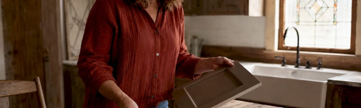 Woman choosing kitchen cabinet color samples