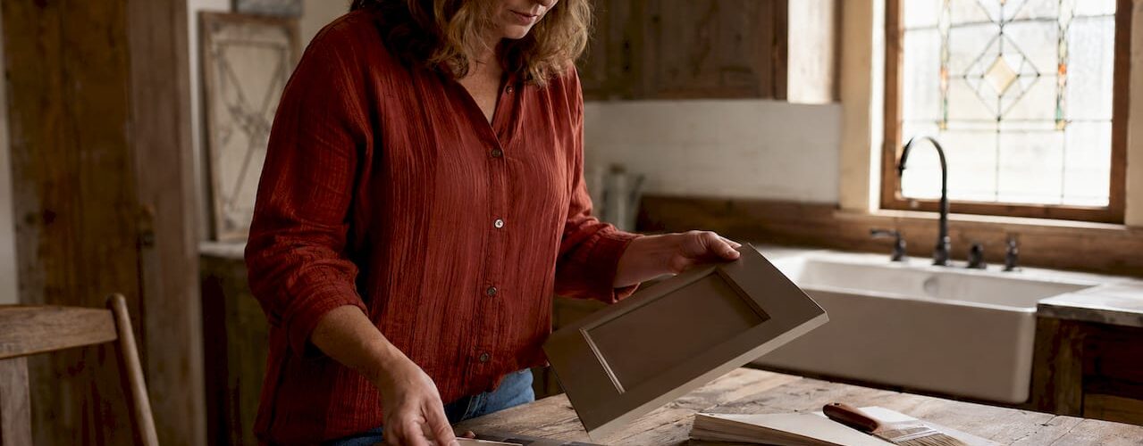 Woman choosing kitchen cabinet color samples