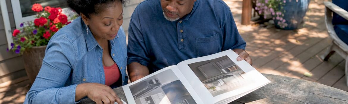 Couple comparing cabinet painting options in kitchen