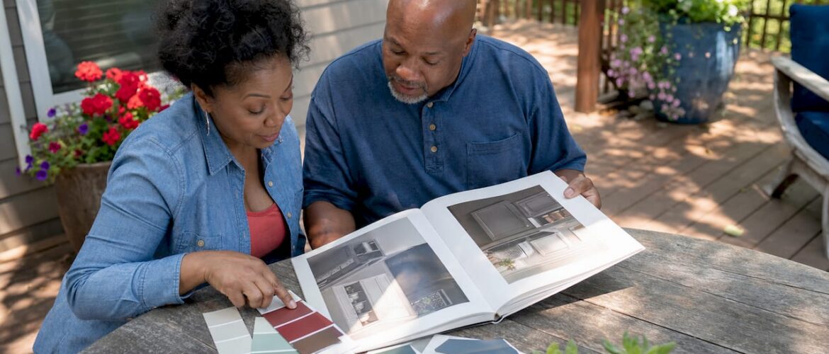 Couple comparing cabinet painting options in kitchen