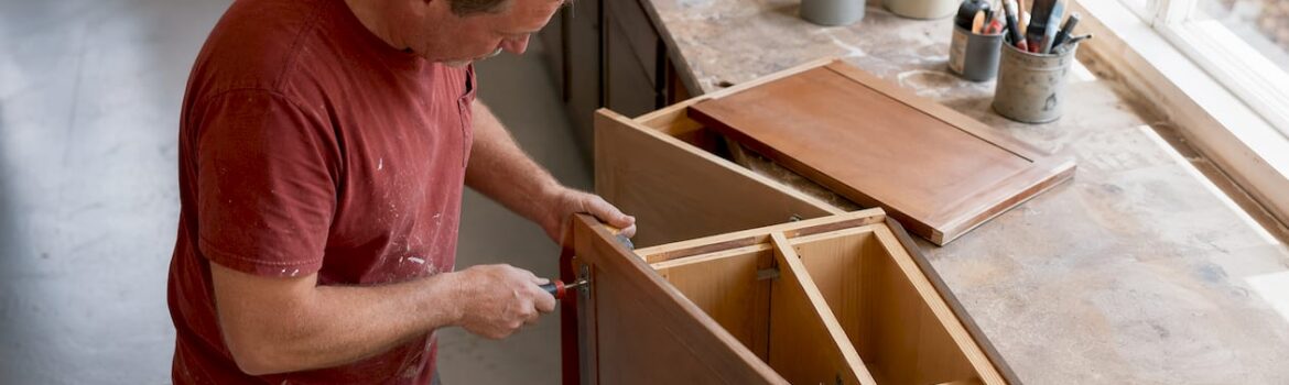 Homeowner removing cabinet doors in kitchen