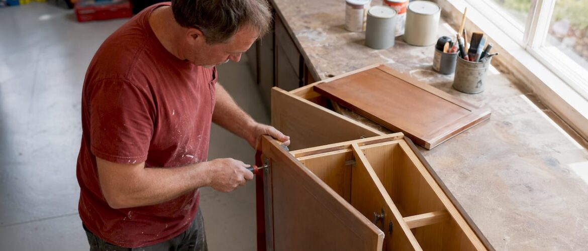 Homeowner removing cabinet doors in kitchen