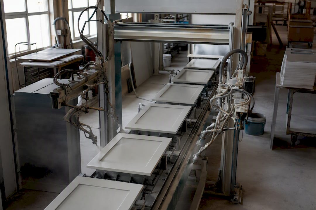 Automated spray line coating cabinet doors