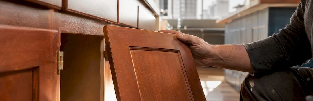 Hands removing condo kitchen cabinet doors