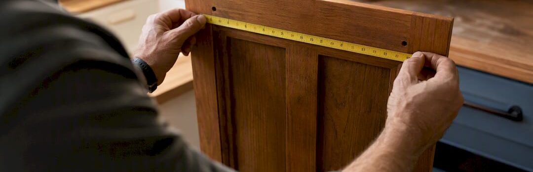 Hands measuring cabinet hardware hole distance