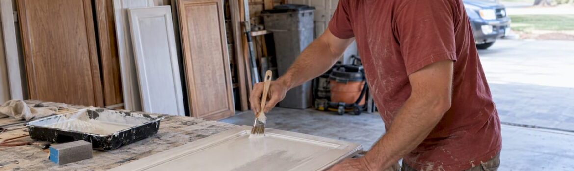 Contractor priming a kitchen cabinet door
