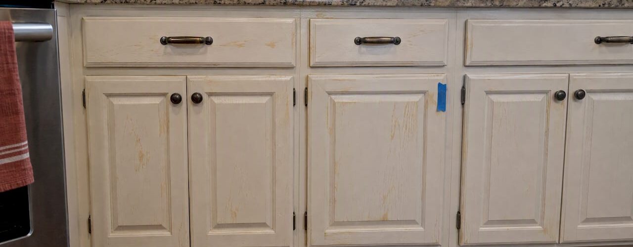 Amber tannin stains showing through painted cabinet doors